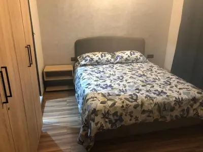 a bedroom with a bed with a blue and white comforter at Apartement in saada fez in Fès