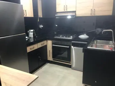 a kitchen with a stove and a sink in it at Apartement in saada fez in Fès