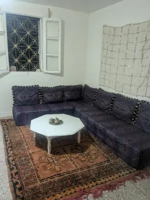 a living room with a couch and a coffee table at Gite montana in Aïn Leuh