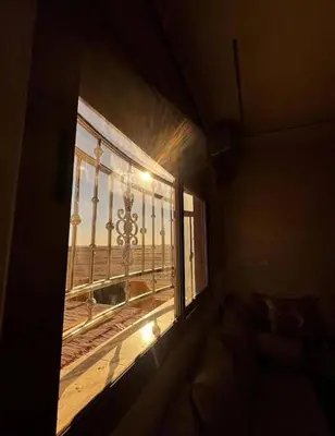 a window in a room with a view of a balcony at Sahara Luxury Apartments in Hassilabied
