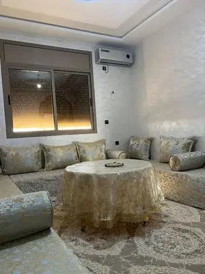 a living room with a couch and a table at Sahara Luxury Apartments in Hassilabied