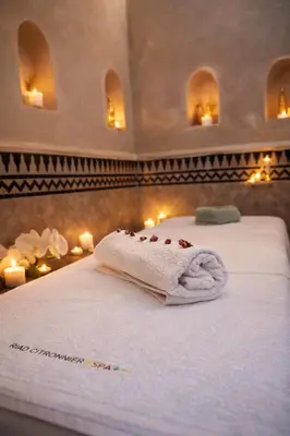 a room with two beds with towels and candles at Riad Citronnier & Spa in Fès