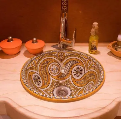 a bathroom sink with an ornate sink at irrigation desert camp in Merzouga