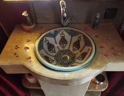 a bathroom sink with a blue and white pattern on it at irrigation desert camp in Merzouga