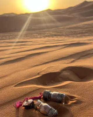 a bottle laying in the sand in the desert at Slik Sand Oasis Camp in Merzouga