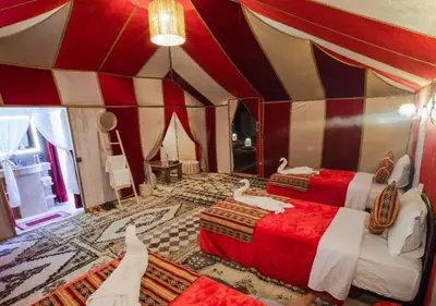 a room with a bed in a circus tent at Slik Sand Oasis Camp in Merzouga