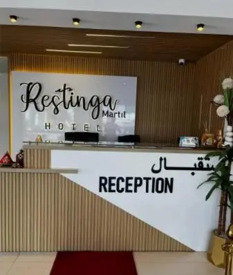a reception area of a hotel with a sign at Restinga in Oulad Akkou
