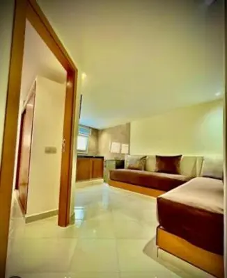 a hotel room with a bed and a couch at Restinga in Oulad Akkou
