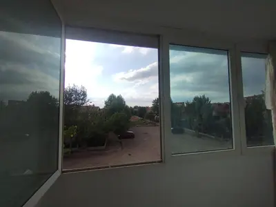 a window with a view of a driveway at Cristal hospitality in Imouzzer Kandar