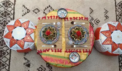 a cake shaped like a train with plates on it at Dar Dallali in Mhamid