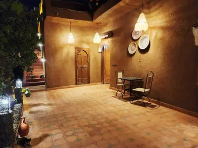 a lobby with a table and plates on the wall at Dar Dallali in Mhamid