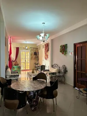 a living room with a table and chairs at Maison Merzouka - Rustic Stay in the Taza Countryside