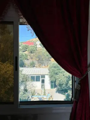 a view of a house from a window at Maison Merzouka - Rustic Stay in the Taza Countryside