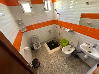 a small bathroom with a toilet and a sink at Maison Merzouka - Rustic Stay in the Taza Countryside