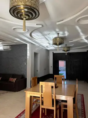 a dining room with a table and a couch at Dar Jabal in Aït Zat
