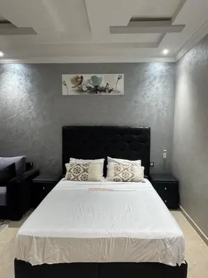a bedroom with a large bed with white sheets at Dar Jabal in Aït Zat