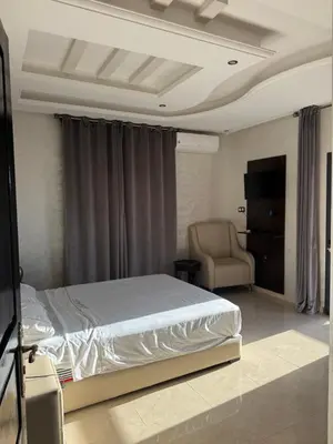 a bedroom with a large bed and a chair at Dar Jabal in Aït Zat