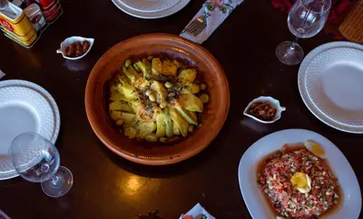 a table with a bowl of food and a plate of food at L'oasis Du Bonheur in Aït Ben Haddou