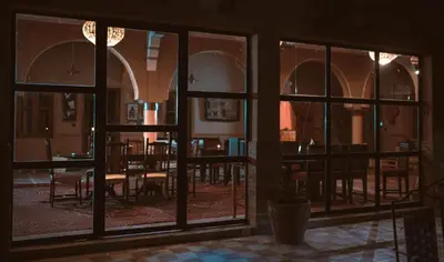 a view of a dining room through a window at L'oasis Du Bonheur in Aït Ben Haddou