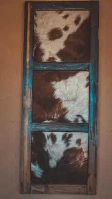 a wooden ladder with brown and white animals on it at L'oasis Du Bonheur in Aït Ben Haddou