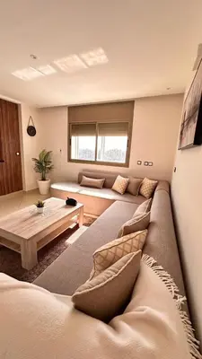 a living room with a couch and a table at Modern Flat in Khouribga in Khouribga