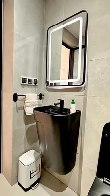 a bathroom with a sink and a mirror at Modern Flat in Khouribga in Khouribga