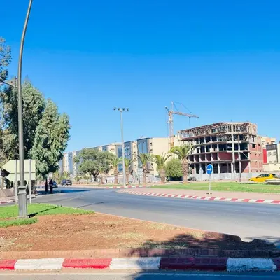 an empty street with a building in the background at Modern Flat in Khouribga in Khouribga