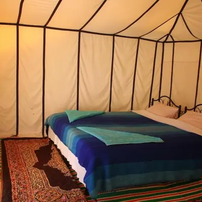 a bedroom with a bed in a tent at Under 1000 Stars Camp in Merzouga
