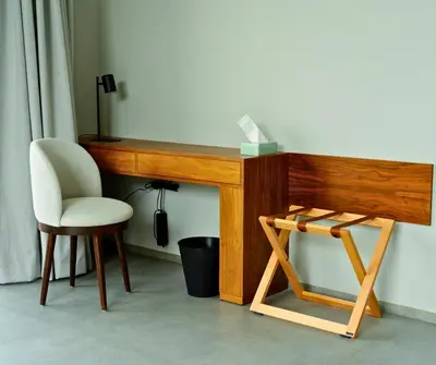 a wooden desk with a white chair and a stool at Villa Timenkar - Moroccan spa and mountain panorama in Aghmat