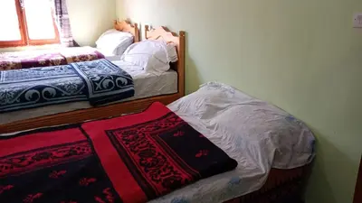 a bedroom with two beds with blankets and pillows at Riad hotel Étoile dades Camping in Aït Ali Ou Allah
