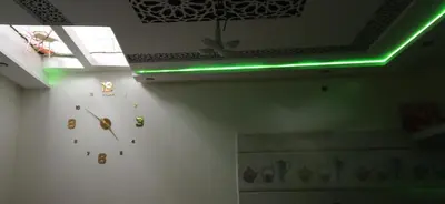 a clock on a wall with a green light at شقة في موقع سياحي لمحبي المناظر الخلابة وشلالات in Beni Mellal