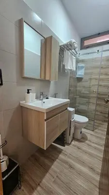 a bathroom with a sink and a toilet and a mirror at 2 bedroom apartment, low price & comfort in Oulad Akkou