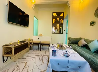 a living room with a couch and a table at Traditional Apartment in Heart of Old Medina in Fès