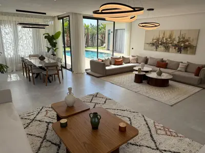 a living room with a couch and a table at Villa B Marrakech Chambre d hôtes Guest House Adult Only piscine privée zéro vis à vis in Marrakech