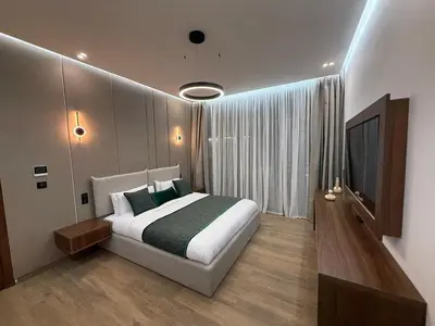 a bedroom with a large bed and a television at Villa B Marrakech Chambre d hôtes Guest House Adult Only piscine privée zéro vis à vis in Marrakech