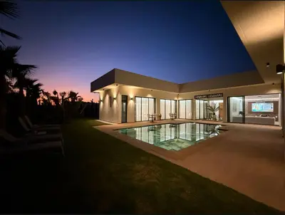 a large house with a swimming pool at night at Villa B Marrakech Chambre d hôtes Guest House Adult Only piscine privée zéro vis à vis in Marrakech