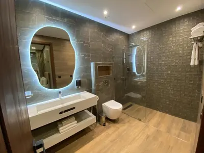 a bathroom with a sink and a mirror at Villa B Marrakech Chambre d hôtes Guest House Adult Only piscine privée zéro vis à vis in Marrakech