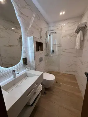 a bathroom with a sink and a toilet and a mirror at Villa B Marrakech Chambre d hôtes Guest House Adult Only piscine privée zéro vis à vis in Marrakech