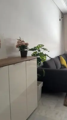 a living room with a white cabinet and a couch at Fleury in Fès
