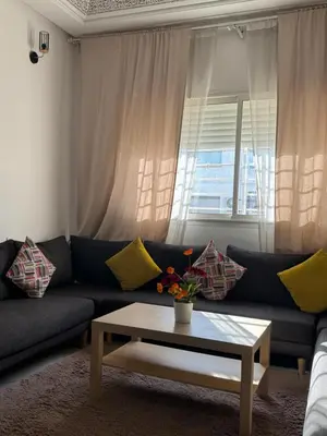 a living room with a couch and a coffee table at Fleury in Fès