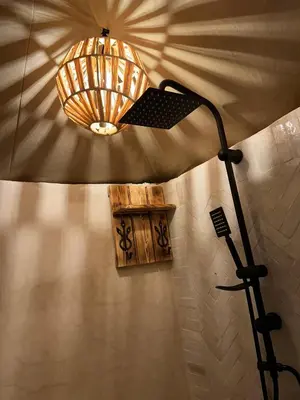 a lamp on a wall with a light on it at Peaceful Luxury Camp in Merzouga