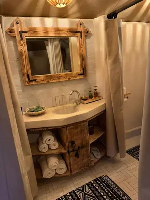 a bathroom with a sink and a mirror at Peaceful Luxury Camp in Merzouga