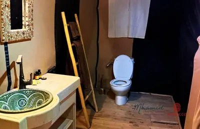 a bathroom with a toilet and a sink at mhamid luxury camps in Mhamid El Ghizlane