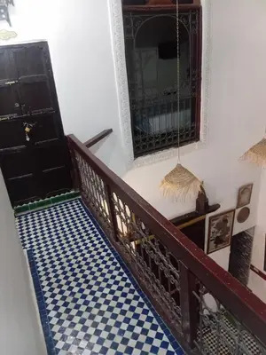 a stairway with a blue and white checkered floor at Riadnomadfes in Fès