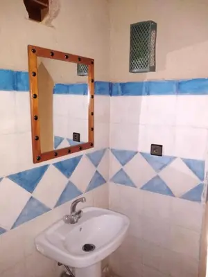 a bathroom with a sink and a mirror at Riadnomadfes in Fès
