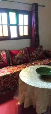 a living room with a couch and a table at Dar chez ali in Mhamid