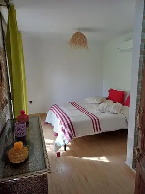 a bedroom with a bed and a table in it at Maison D'hôte - Villa Privée et Paisible avec Déj' Marocain Offert