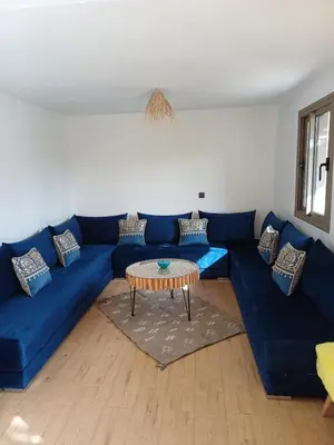 a living room with a blue couch and a table at Maison D'hôte - Villa Privée et Paisible avec Déj' Marocain Offert
