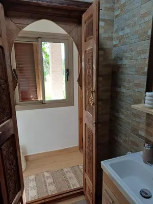 a bathroom with a sink and a window at Maison D'hôte - Villa Privée et Paisible avec Déj' Marocain Offert