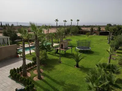 an aerial view of a park with palm trees and a playground at Maison D'hôte - Villa Privée et Paisible avec Déj' Marocain Offert